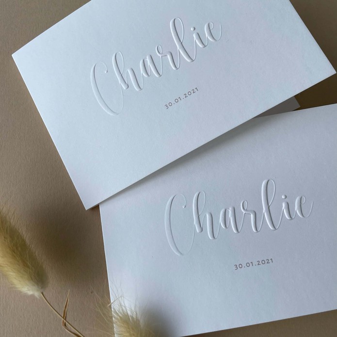 Gevouwen unisex geboortekaartje met naam in reliëfdruk verhoogd