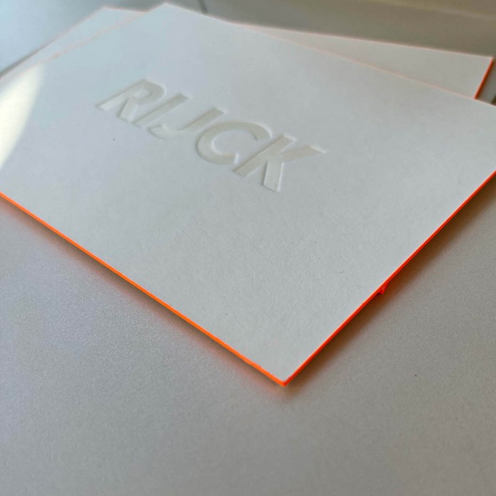 Minimalistisch geboortekaartje met witte folie en oranje zijkant